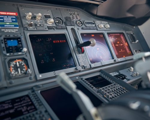 Aircraft flight deck with flight displays, switches and knobs