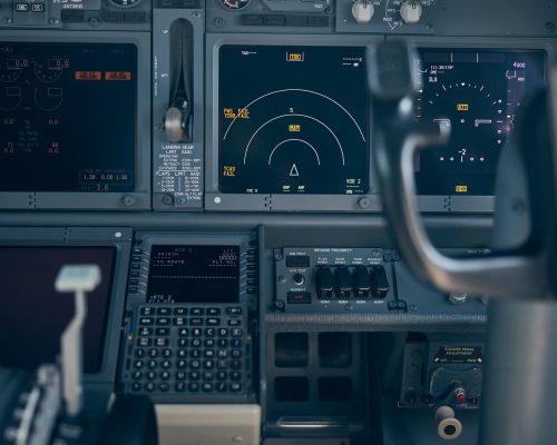 Aircraft flight deck with switches and flight displays